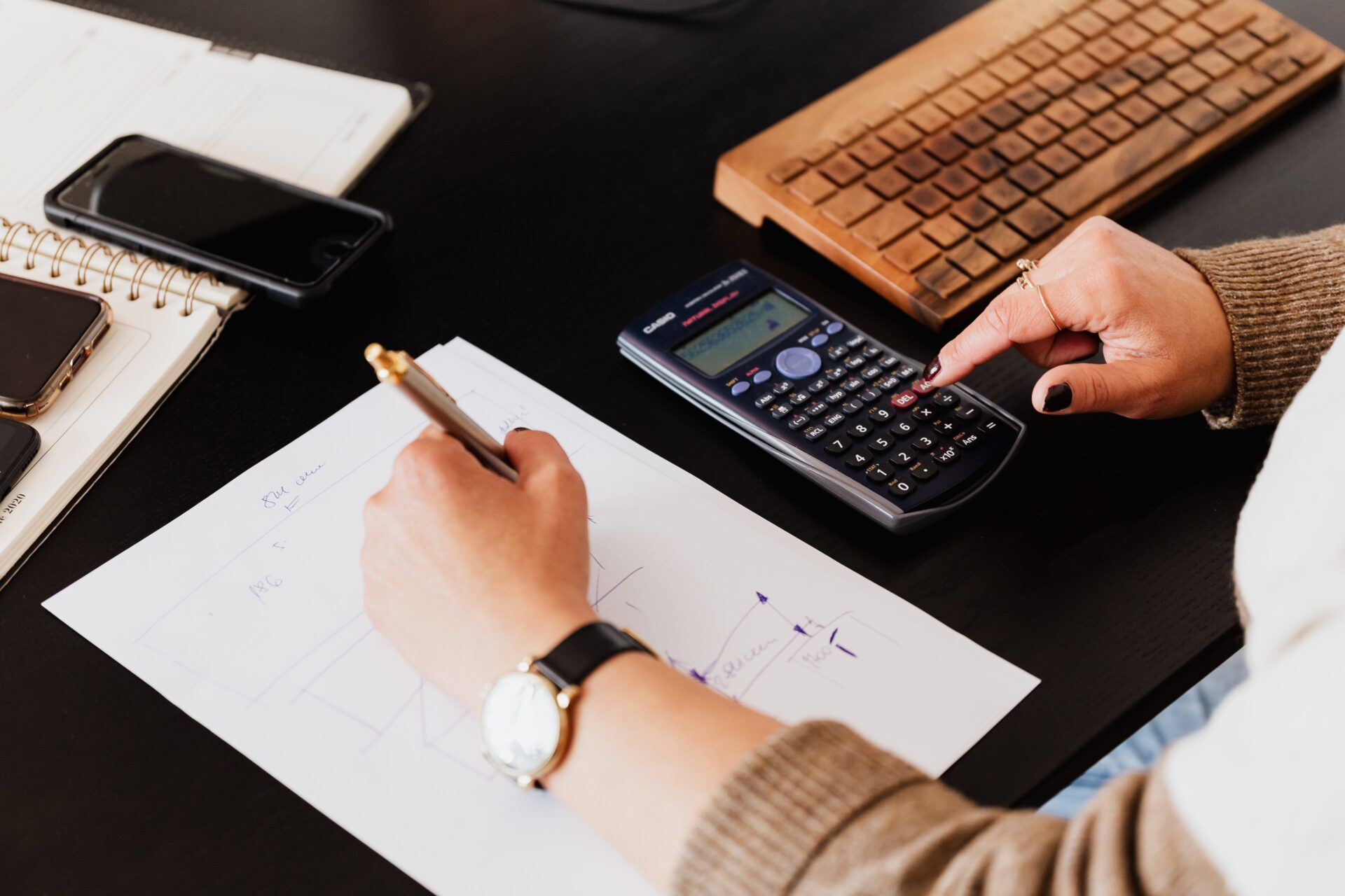 Bookkeeper Writing Down on Paper while using Calculator Bookkeeper Writing Down on Paper while using Calculator<br />